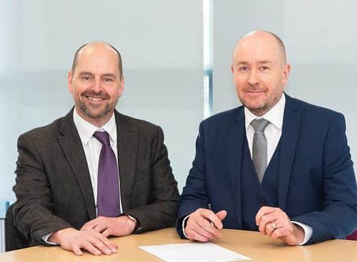 Mike Perry and Ian Millard shaking hands over the framework agreement. Picture: Contributed