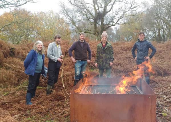 A group making biochar from waste left over from rhododendron removal. Ed Tyler (2nd from left) is a member of the Green Network Project team and he and his wife Carina Spink (on the far left) are Directors of Local Bioregioning CIC.