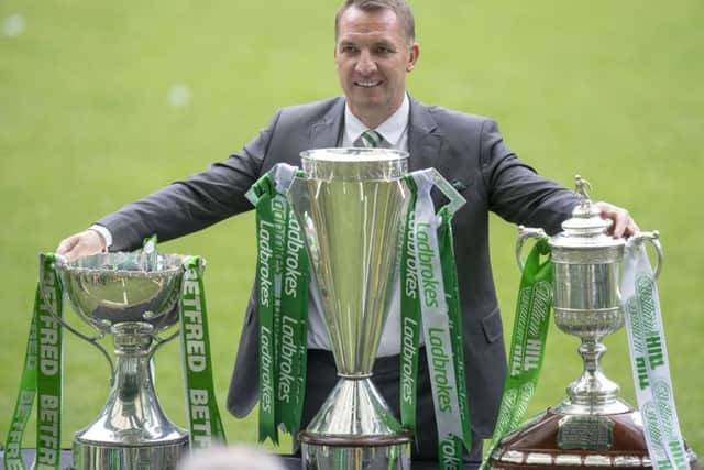 Brendan Rodgers with the Scottish League Cup, Scottish Premiership trophy and the Scottish Cup. Picture: SNS Group