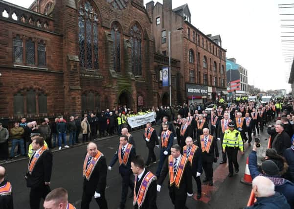 Orange marchers walk past St Alphonsus Chapel in Glasgow (Picture: John Devlin)