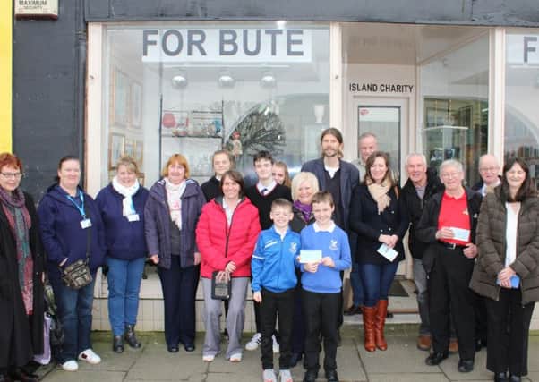 Pictured outside For Butes Victoria Street shop are shop volunteers and representatives  of the organisations who have benefited from the popular thrift shops latest round of awards.