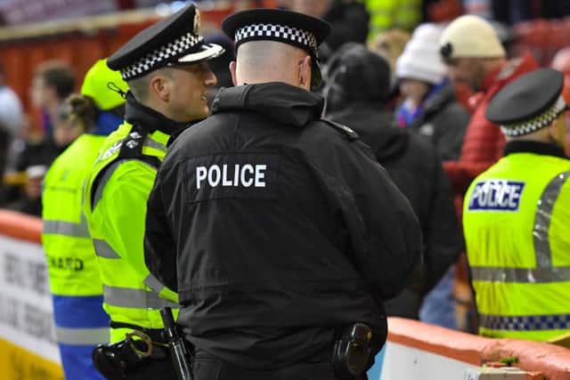 Police officers working at the football. Picture: SNS