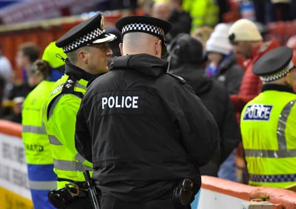 Police officers working at the football. Picture: SNS