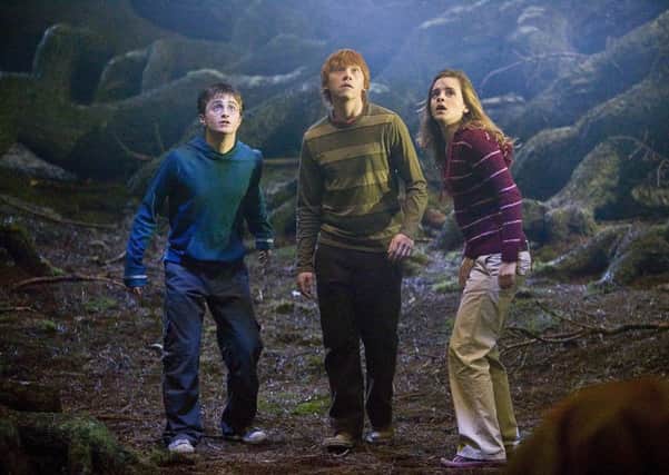 Daniel Radcliffe as Harry Potter, with Rupert Grint and Emma Watson