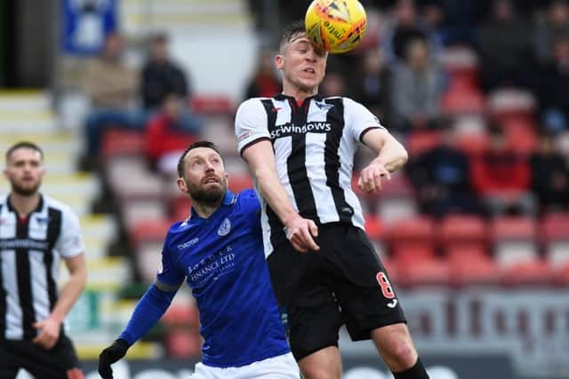 Dunfermlines Tom Beadling challenges Stephen Dobbie. Photograph: Ross MacDonald/SNS Group