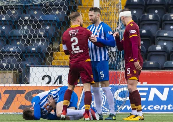 Kilmarnock's Stephen O'Donnell collapses to the ground as Richard Tait and Kirk Broadfoot exchange words. Pic: SNS/Alan Harvey