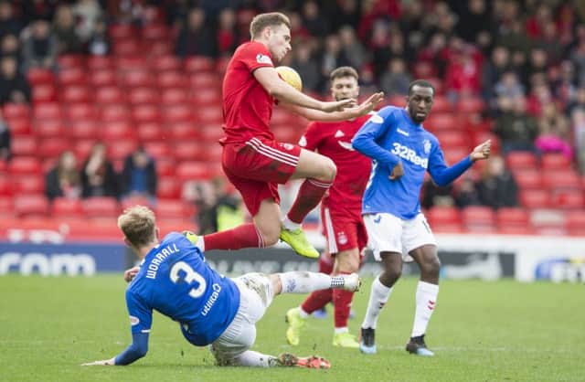Greg Stewart jumps over Rangers defender Joe Worrall during the Scottish Cup clash in Aberdeen. Picture: PA