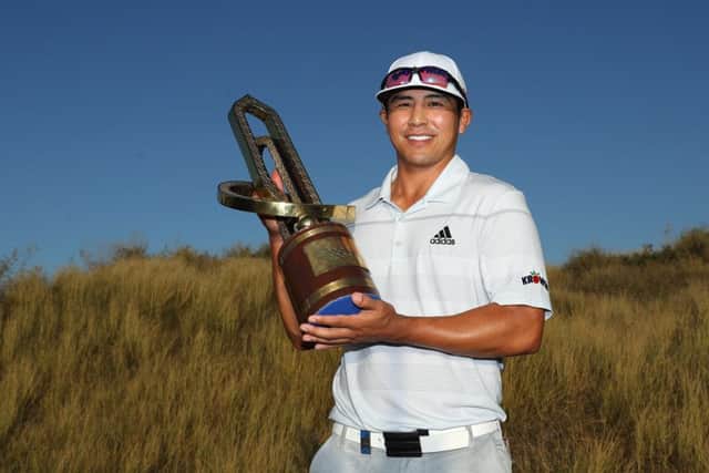 Kurt Kitayama holds the trophy after winning the Oman Open at Al Mouj Golf. Picture: Warren Little/Getty Images