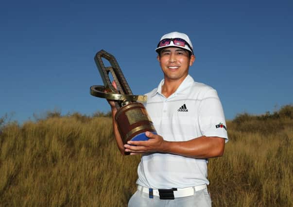 Kurt Kitayama holds the trophy after winning the Oman Open at Al Mouj Golf. Picture: Warren Little/Getty Images