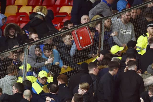A seat is thrown as Rangers and Aberdeen fans clash at Pittodrie. Picture: SNS