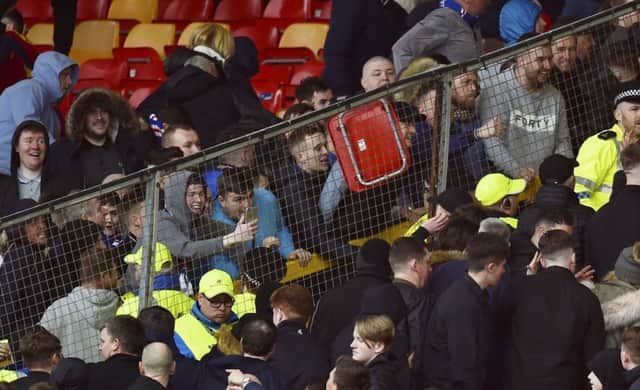 A seat is thrown as Rangers and Aberdeen fans clash at Pittodrie. Picture: SNS