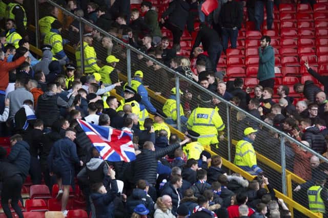 A seat is thrown as Aberdeen and Rangers fans clash at Pittodrie. Picture: SNS Group