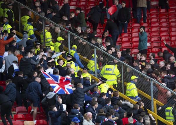 A seat is thrown as Aberdeen and Rangers fans clash at Pittodrie. Picture: SNS Group