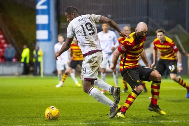 Ikpeazu clashes with Gary Harkins in the box - but no penalty was given. Picture: SNS Group