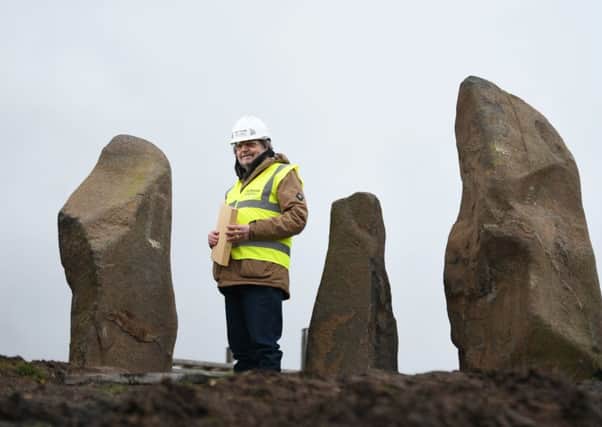 Science writer Duncan Lunan inspects the new site of his modern-day stone circle, which has been moved in its entirety as part of a £250m regeneration of Glasgow's Sighthill area. Picture: John Devlin