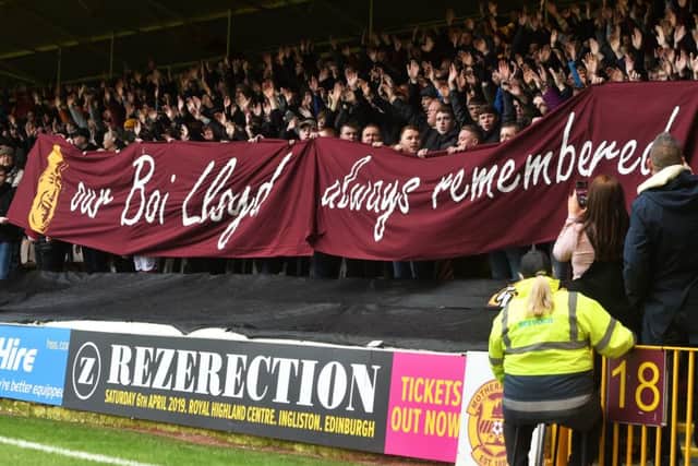 Motherwell fans unveil a banner paying tribute to a supporter who passed away.