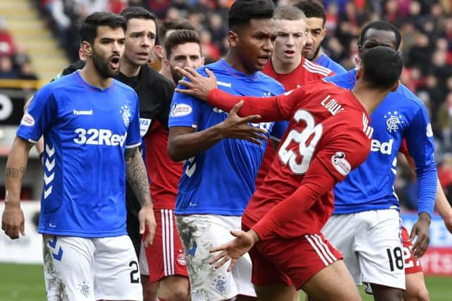 Rangers' Alfredo Morelos clashes with 
Aberdeen's Max Lowe in the Scottish Cup quarter-final at Pittodrie. Picture: SNS