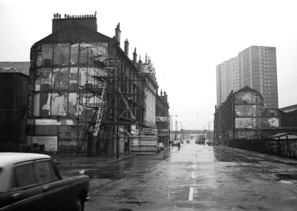 High-rise buildings overshadow the Palace bingo hall and Citizens Theatre in Gorbals Street Glasgow in February 1976.