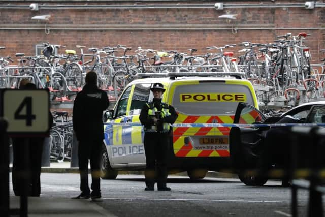 A police-woman stands guard outside a police cordon at Waterloo Station. Picture: Getty Images