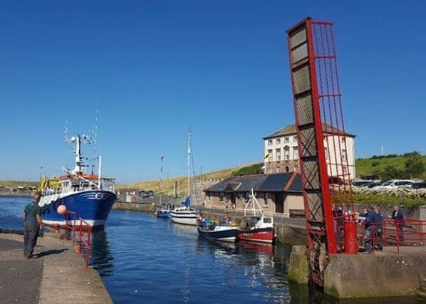 Eyemouth's red bridge opened to let a boat through to the boat yard.