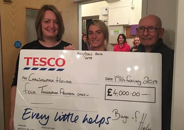 Smiles all round at the presentation of the Tesco donation to the Castle Douglas home.