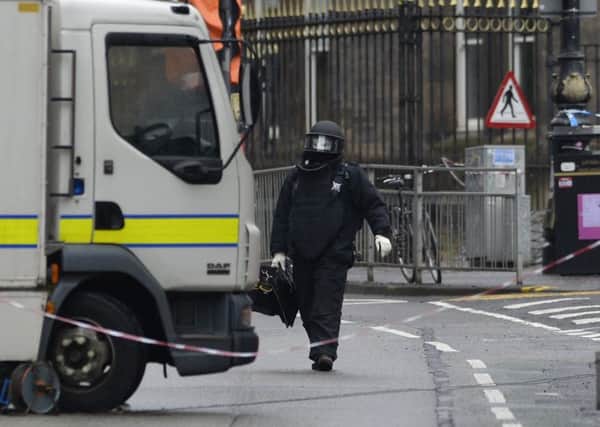 A member of the Royal Logistics Bomb Disposal returns to his van at Glasgow University appearing to be carrying a package as the university remains on shut down following reports of suspect packages. Picture: SWNS
