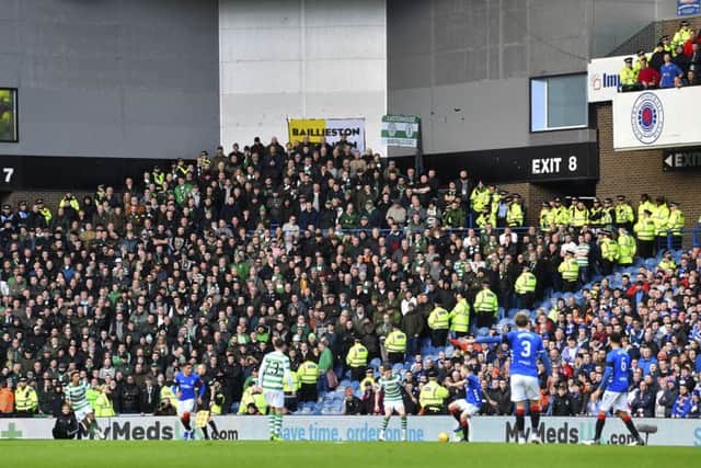 Celtic and Rangers fans are separated by stewards and police during the clash at Ibrox. Picture: SNS Group