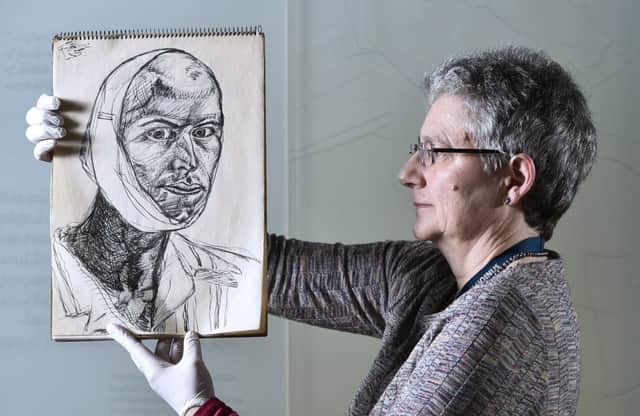 Curator Dorothy Kidd holds a sketch by Edwin Lucas, from 1943 or 1944. Picture: Neil Hanna