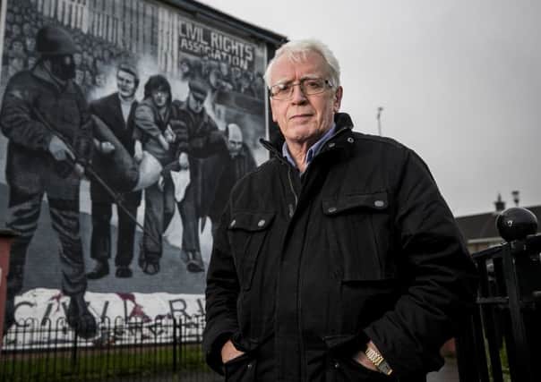 John Kelly whose brother 17 year old Michael was killed in Derry on Bloody Sunday standing beside the Bogside mural showing a white handkerchief being waved by Fr Edward Daly as the body of Jackie Duddy was carried from where he was shot in the courtyard of Rossville Flats. Picture: Liam McBurney/PA Wire