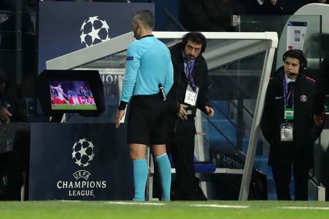 Referee Damir Skomina studies the VAR system prior to awarding Manchester United a penalty against PSG. Picture: John Walton/PA Wire