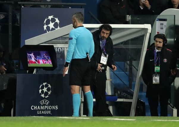 Referee Damir Skomina studies the VAR system prior to awarding Manchester United a penalty against PSG. Picture: John Walton/PA Wire