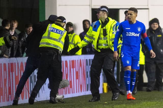 Rangers captain James Tavernier was confronted by a fan who ran onto the pitch. Picture: Craig Foy/SNS