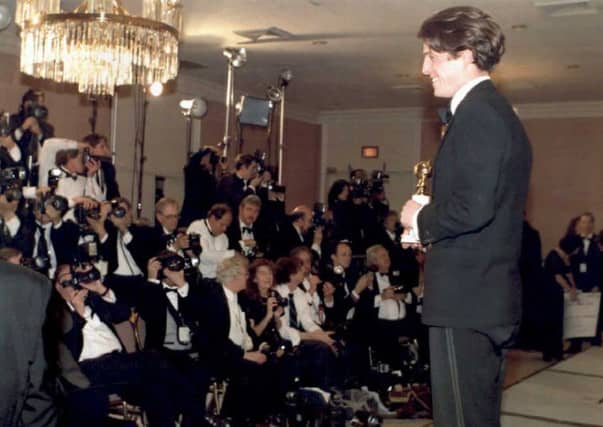 Hugh Grant poses with his Golden Globe Award for best actor in a musical-comedy in 1995 for his role in Four Weddings and a Funeral (Picture: STR/AFP/Getty Images)
