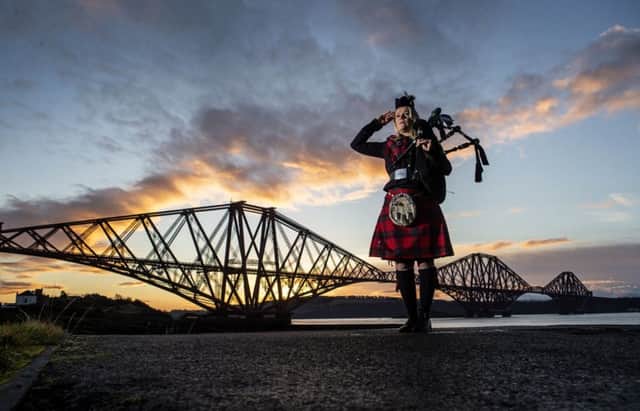 Piper Louise Marshall, wearing a special commemorative red tartan, plays Battle's O'er, the traditional Scottish lament played at the end of battle, at dawn alongside the Forth Bridge at North Queensferry on the 100th anniversary of the signing of the Armistice which marked the end of the First World War. PRESS ASSOCIATION Photo. Picture date: Sunday November 11, 2018. See PA story MEMORIAL Armistice. Photo credit should read: Jane Barlow/PA Wire