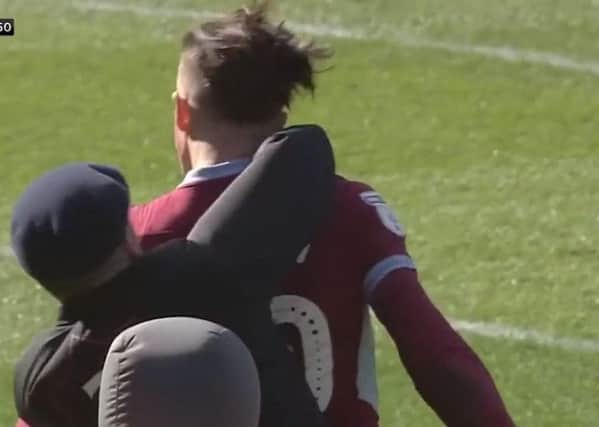 Screengrab taken from Sky Sports Football of a fan attacking Aston Villa's Jack Grealish during the Sky Bet Championship match at St Andrew's Trillion Trophy Stadium, Birmingham. Picture: Sky Sports/PA Wire.
