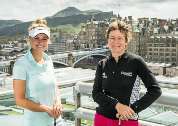 Carly Booth, pictured with Catriona Matthew in Edinburgh in 2013, is determined to make the Scot's Solheim Cup team at Gleneagles in September. Picture: Ian Georgeson