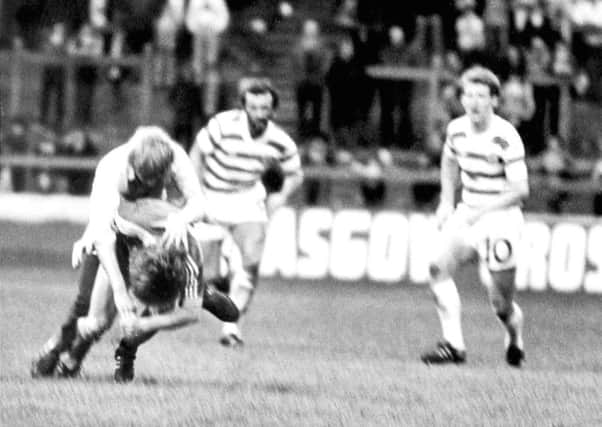 Aberdeens Gordon Strachan is attacked by a fan who ran on to the pitch during a match against Celtic at Parkhead in November 1980