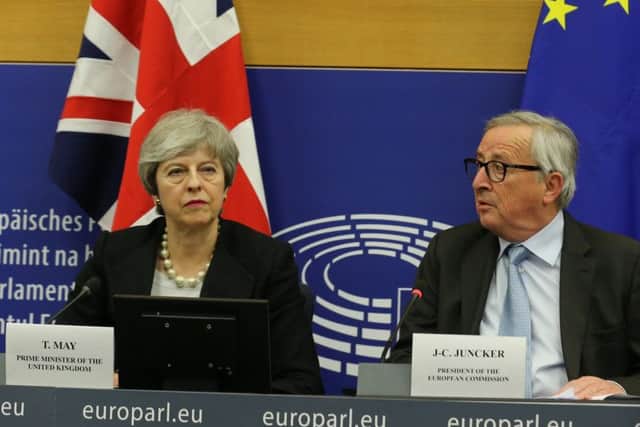 Theresa May with Jean-Claude Juncker.  (Photo by Thomas Niedermueller/Getty Images)