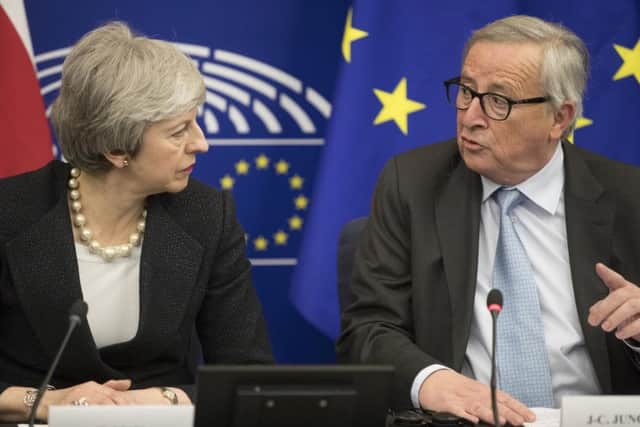 Prime Minister Theresa May and European Commission President Jean-Claude Juncker. (AP Photo/Jean-Francois Badias)