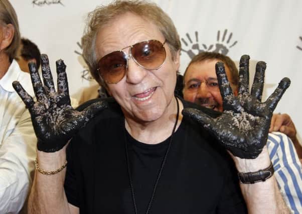 Hal Blaine holds up hands covered in wet cement following an induction ceremony at Hollywoods RockWalk in Los Angeles in 2008. Picture: AP