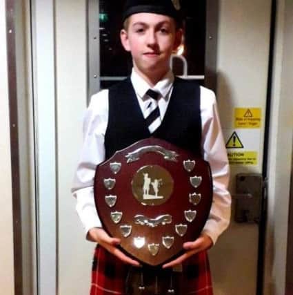 Alister Booth (14) of The Isle of Bute Schools Pipe Band with the Scottish Schools Pipe Band Championship.