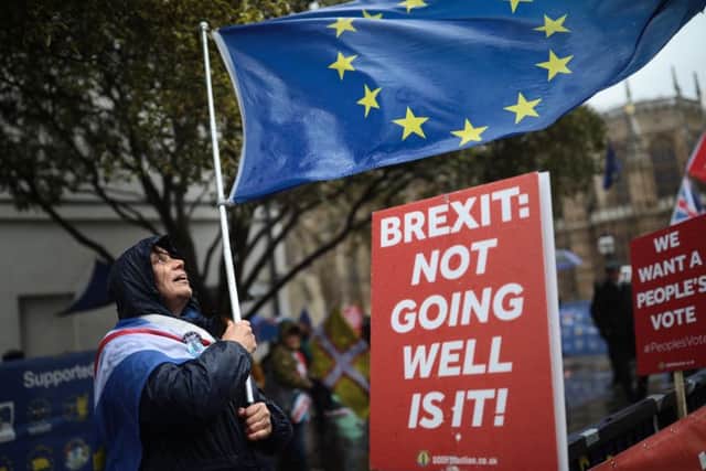 LONDON, ENGLAND - MARCH 12:  Anti Brexit demonstrators protest in the rain ahead of the meaningful vote in Parliament on March 12, 2019 in London, England. MPs, who rejected Theresa May's Brexit deal earlier this year by a majority of 230, are due to vote on revised proposals after Theresa May secured last-minute legally binding changes, wanted to ensure the UK couldnt be indefinitely tied to the Irish backstop and a permanent customs union. (Photo by Dan Kitwood/Getty Images)