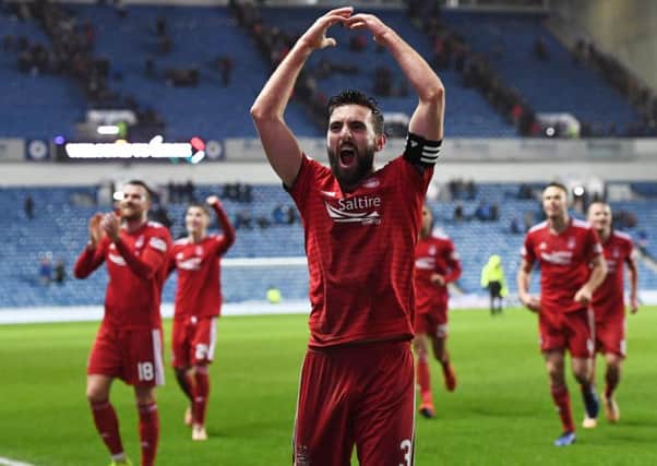 Captain Graeme Shinnie leads the celebrations as Aberdeen knock Rangers out of the Scottish Cup. Picture: SNS Group