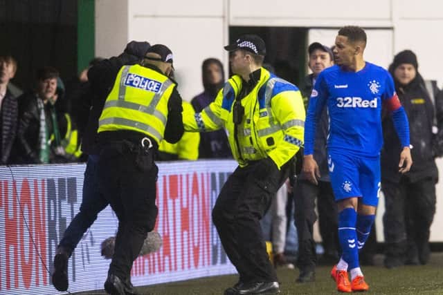 James Tavernier looks on as police arrest a spectator who confronted the Rangers captain. Picture: SNS Group