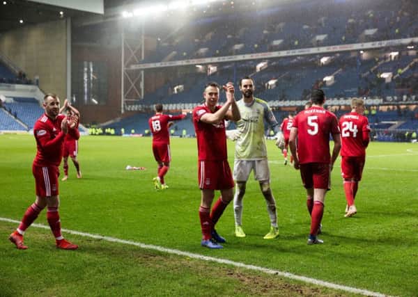 Aberdeen players celebrate the cup win at Ibrox. Picture: Robert Perry/PA Wire