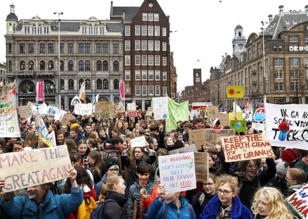 Youth protests in Amsterdam yesterday while Edinburgh school student Sandy Boyd, above right, will help rally Scottish action today. Picture: Getty