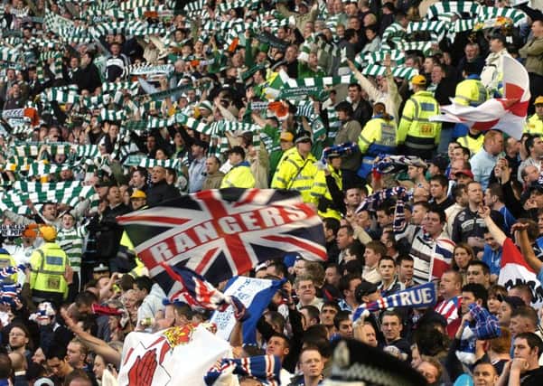 Celtic and Rangers fans during a derby match. Jim Duffy has no plans to join them (Picture: Ian Rutherford)