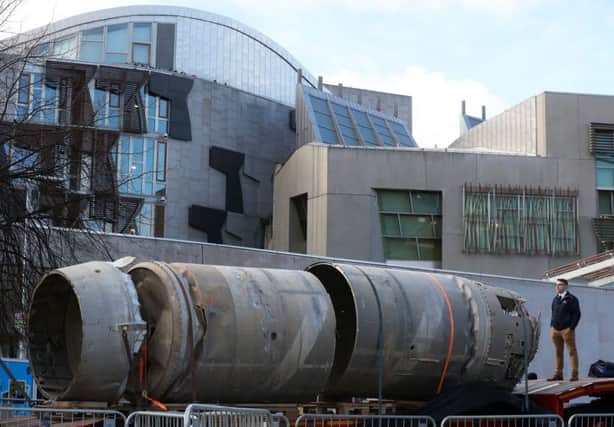Owain Hughes views the Black Arrow rocket
outside the Scottish Parliament, Edinburgh. Picture: Andrew Milligan/PA Wire