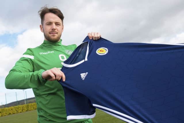 Marc McNulty weighs up a Scotland jersey, which he could be wearing in the forthcoming matches against Kazakhstan and San Marino. Picture: SNS.