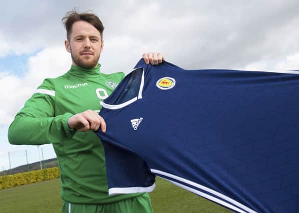 Marc McNulty weighs up a Scotland jersey, which he could be wearing in the forthcoming matches against Kazakhstan and San Marino. Picture: SNS.